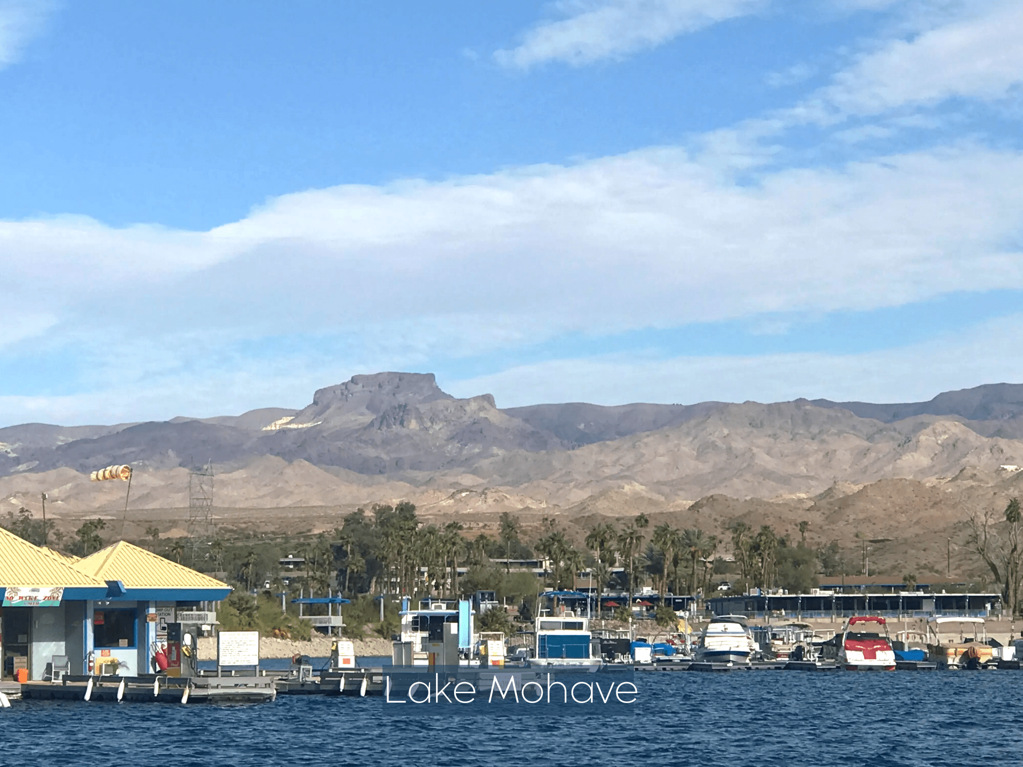 Lake Mohave with boats and desert mountains in the background.